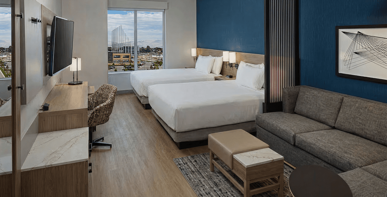Furnished Hyatt Place guest room in Dania Beach with two beds, a work desk and warm accent lighting